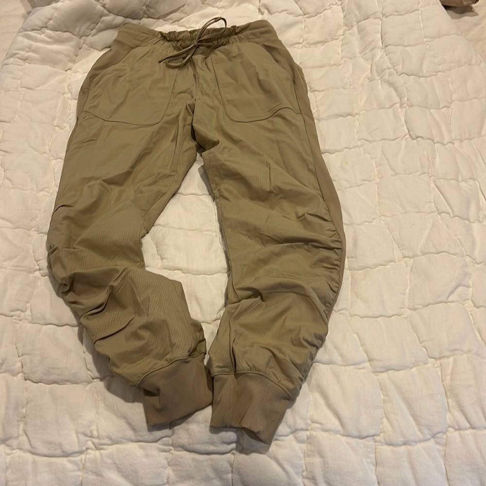 Size 6 tan Lululemon track pants.